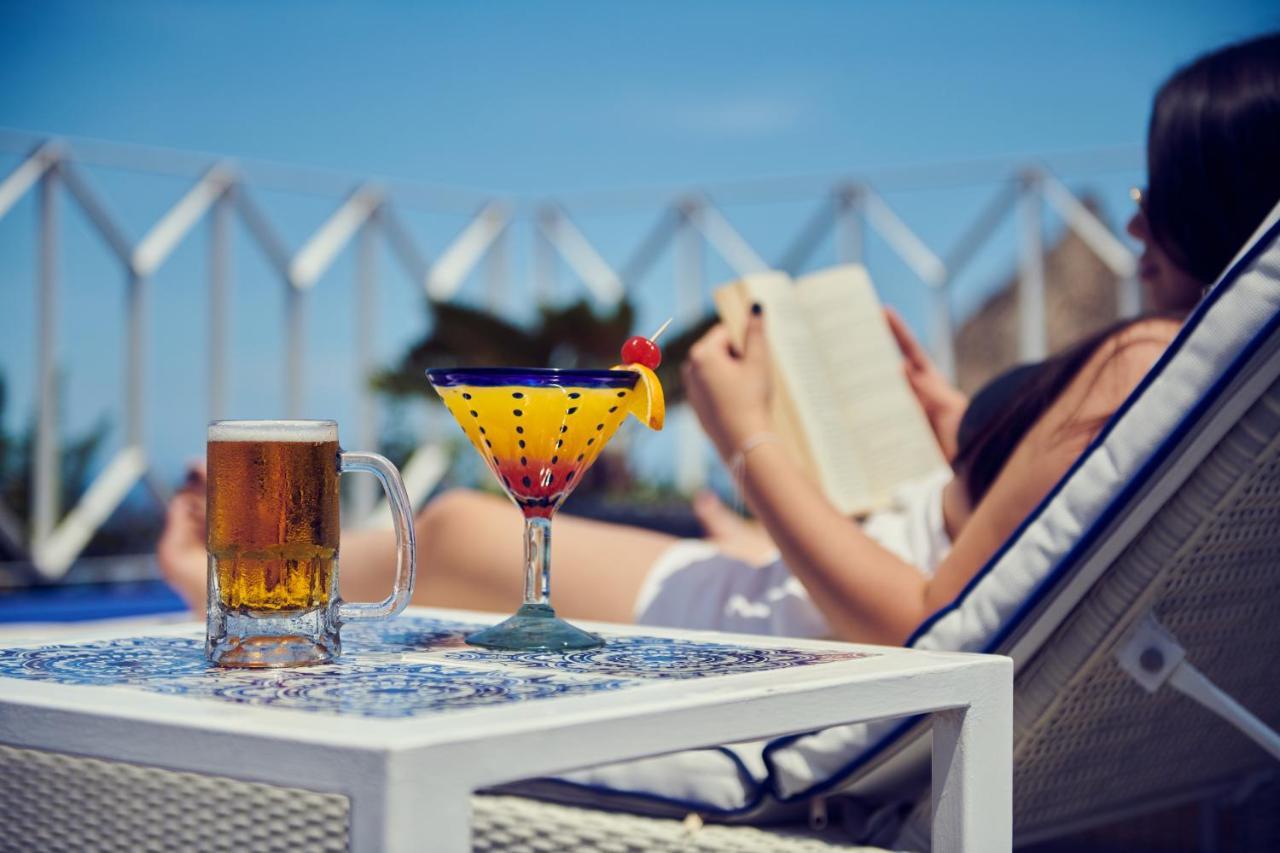 Hotel Luxury Patio Azul (Adults Only) Puerto Vallarta Bagian luar foto A woman reading a book by the pool